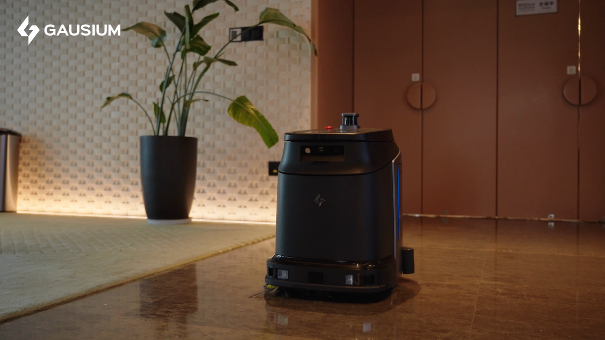 Robotic vacuum cleaner on a tiled floor with a plant and wall in the background, featuring the Gausium brand.